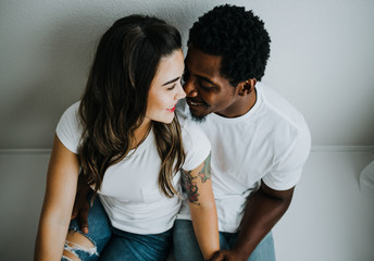 Happy Biracial Couple in Modern White Room