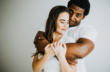 Happy Biracial Couple in Modern White Room