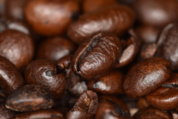 he unique texture of brilliant fragrant grains of roasted coffee on fire close-up