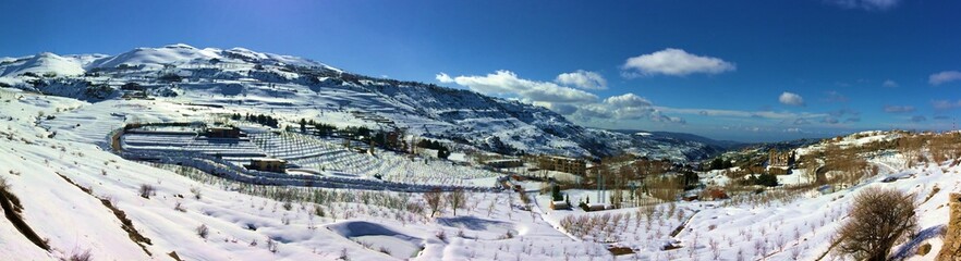 Fototapeta premium panorama of winter mountains in Kfardebiane, Lebanon, with beirut in a far end