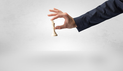 Big elegant hand taking his next step on chess game
