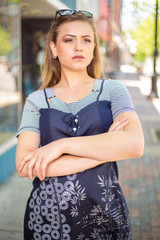 Cute teenage female fashion model on sidewalk