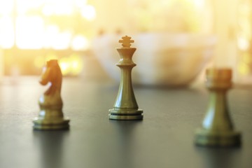 gold metal chess with bokeh background