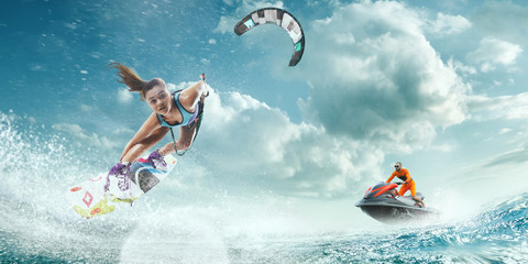 Kite surfing and water scooter in tropical ocean.