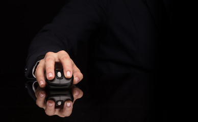 Hand using wireless mouse in a dark environment
