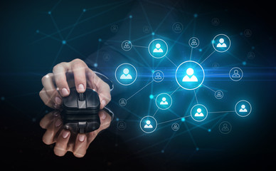 Hand using wireless mouse in a dark environment with human network concept