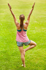 Young woman doing yoga in park