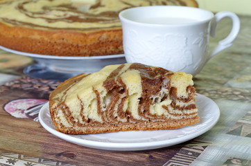 A piece of cake Zebra and a Cup of milk on the table