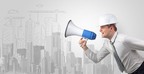 Fototapeta premium Young supervisor architect yelling to a big city panorama 