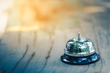 Bell metal on wood table with empty blurred background of service