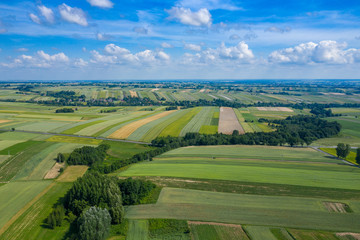 Fototapeta na wymiar Aerial view of farmlands and mountains in rural Poland seen from drone. Summer time.