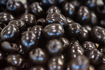 Canned black pitted olives for abstract background