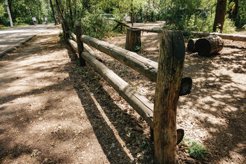 wooden fence in the center of the forest edge