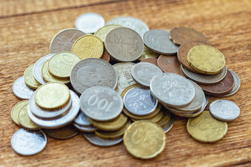 coins old rusty brass euro Seychelles Bulgaria China Germany pile pack heap stack on a wooden background finance economy investment savings concept mock up selective focus close up