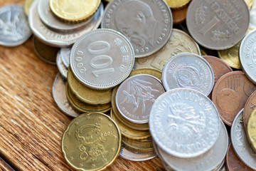 coins old rusty brass euro Seychelles Bulgaria China Germany pile pack heap stack on a wooden background finance economy investment savings concept mock up selective focus close up