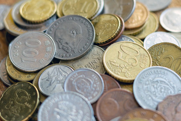 coins old rusty brass euro Seychelles Bulgaria China Germany pile pack heap stack on a wooden background finance economy investment savings concept mock up selective focus close up