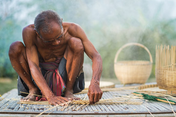 Senior man and bamboo craft, lifestyle of the locals in thailand - obrazy, fototapety, plakaty
