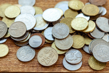 coins old rusty brass euro Seychelles Bulgaria China Germany pile pack heap stack on a wooden background finance economy investment savings concept mock up selective focus close up
