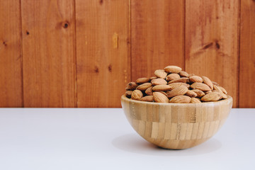 natural almonds isolated in a bowl