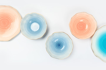 Set of colored ceramic plates on white background