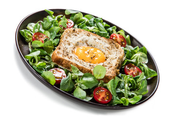 Breakfast - toasted bread with fried egg and vegetables
