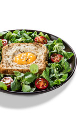 Breakfast - toasted bread with fried egg and vegetables