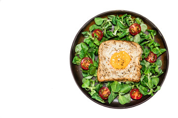 Breakfast - toasted bread with fried egg and vegetables