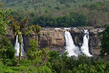 waterfall in the mountains named 'athirappilli' located in kerala, india