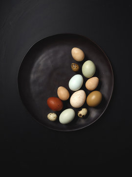 Colorful Eggs on Black Plate