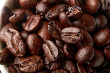 aromatic roasted coffee beans on white background