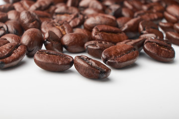 aromatic roasted coffee beans on white background
