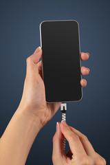 Close-up view of hand charging smartphone