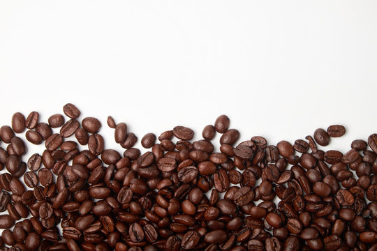 aromatic roasted coffee beans on white background © Mikhail