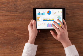 Hand making diagrams and charts on tablet