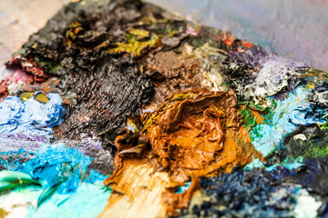 Background image of bright oil-paint palette closeup.