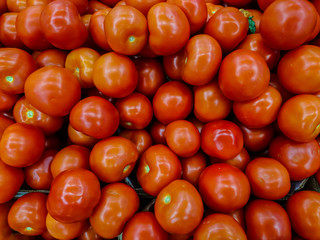 Ripe red tomatoes for salad, close-up on the background, vegetables for a healthy diet.