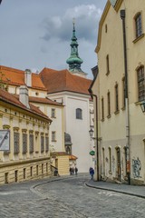 Obraz premium alleys of the old town in Brno, cobbled, winding streets on the hill, tourists visiting the city rich in monuments, churches and souvenirs of famous residents