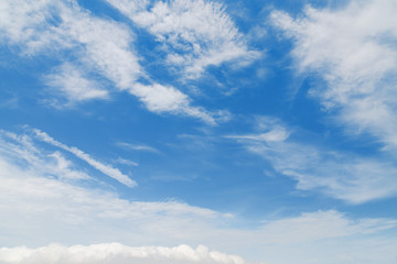 Naklejka na ściany i meble Fluffy white clouds in a blue sky