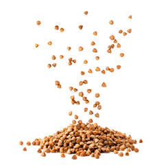 Buckwheat seeds fall in a pile on a white, isolated.