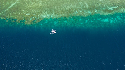 Obraz premium Boat on the Philippines - Aerial drone photo of ship on coral reef. Philippine boat at the coral reef, view from above.