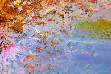 Background image of bright oil-paint palette closeup.