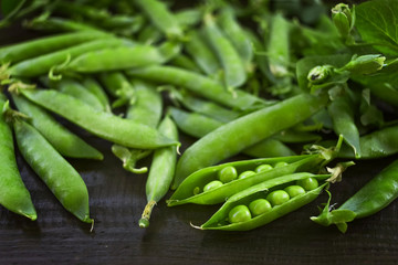 green pea pods on the table close-up. background with green peas.