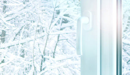 Metal plastic window construction with snow winter weather outside. Pvc profile in window construction. Copy space.
