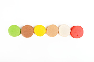 Macaroons on a white background. A row of colored macaroons. View from above.