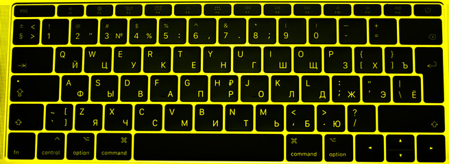 Computer keyboard. Modern, compact black keyboard in a yellow case.