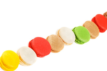 Macaroons on a white background. A row of colored macaroons. Diagonal composition.