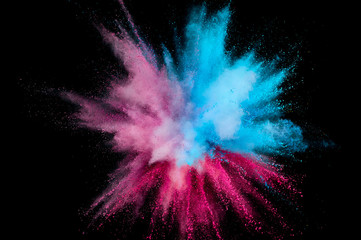 Colored powder explosion. Abstract closeup dust on backdrop. Colorful explode. Paint holi