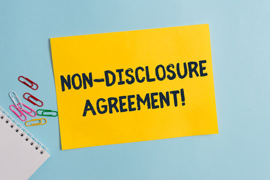 Text sign showing Non Disclosure Agreement. Business photo showcasing Legal Contract Confidential Material or Information Plain cardboard and writing equipment placed above pastel colour backdrop