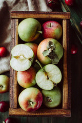 Homemade ripe garden apples in a wooden box