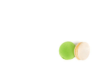 Sweet fresh macaroons. Two macaroons lying on top of each other on a white background, green and white.